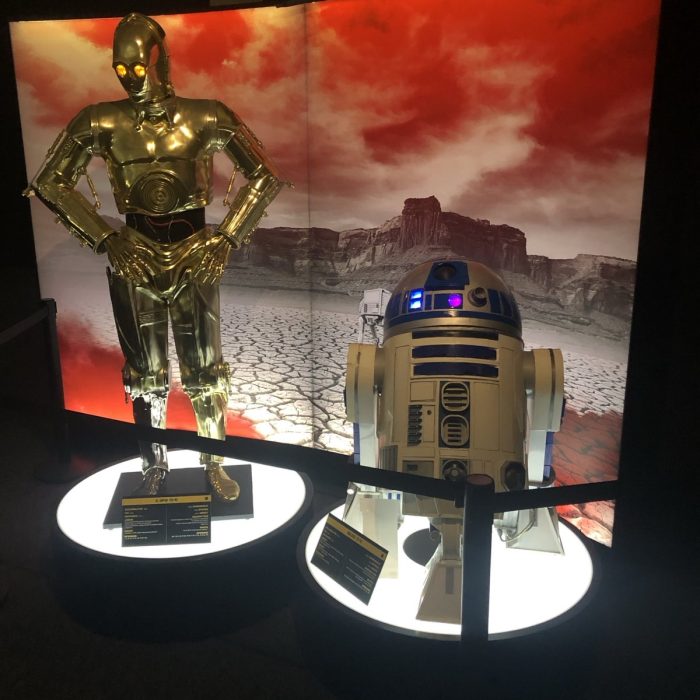 Star Wars exhibition installation: R2-D2 and C-3PO droids against a backdrop depicting the planet Crait.