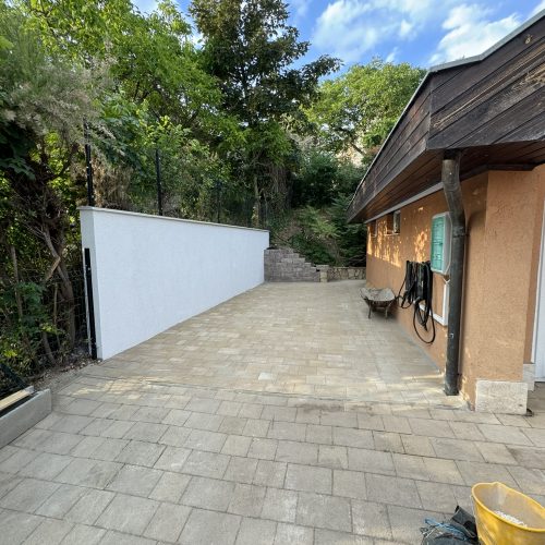 Premium hardscaping and fence construction: an expertly installed driveway paired with an elegant fence.